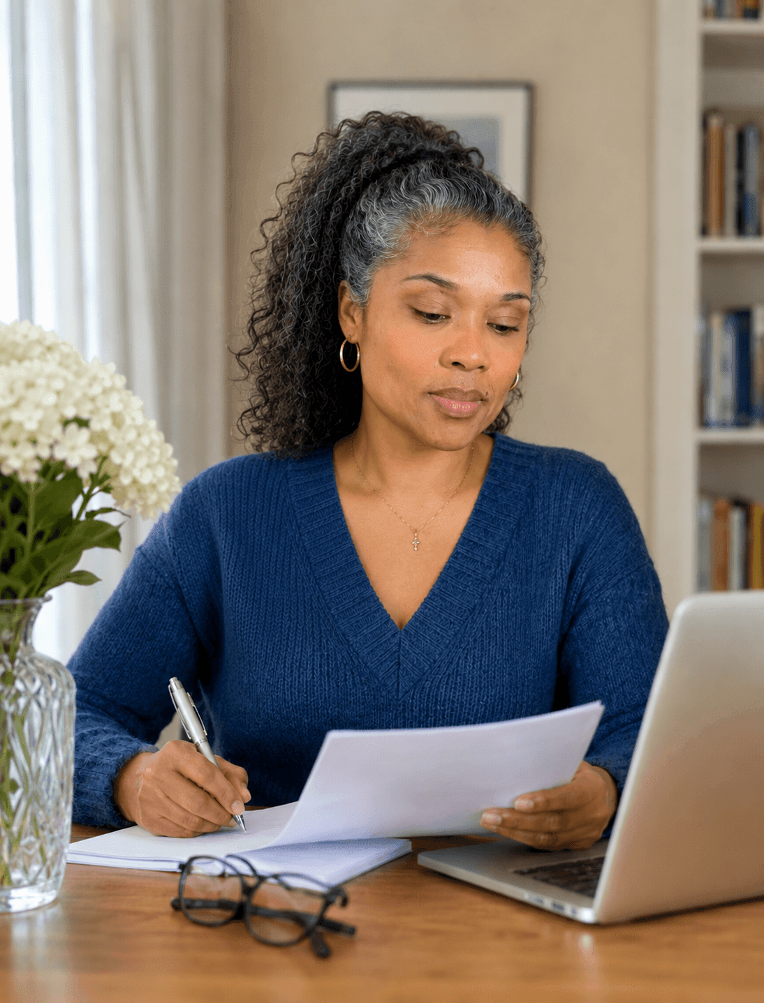 AI-generated-image-regina-reviewing paperwork by a laptop